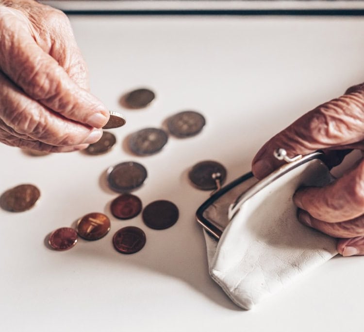shutterstock_2453982845 (1) hands counting change with a purse